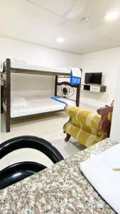 a small room with a bunk bed and a counter at Apartahotel 222 Apartamento 503 in Pereira +2 photos