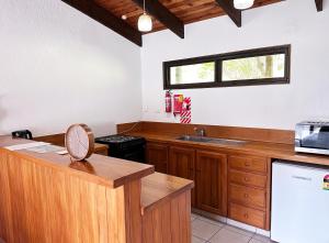 a kitchen with wooden cabinets and a counter top at Haruru Falls Motel & Conference Centre in Paihia