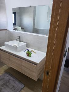 a bathroom with a sink and a mirror at Appartement haut standing avec piscine in Dakar