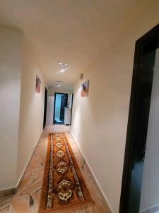 an empty hallway with a rug on the floor at Moca hostel in Dubai
