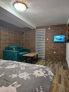 a living room with a bed and a couch at City View Apartment in Bijelo Polje