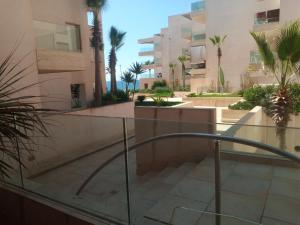 a view from the balcony of a building with palm trees at Apparemment Rockisland in Mohammedia