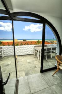 a view of a patio with a table and the ocean at Villa Sotavento Adults Only in Playa Jandia