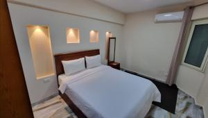 A bed or beds in a room at Alex sea view apartment - families only