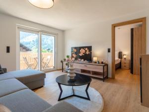 a living room with a couch and a table at Villa Felding Top 4 in Bad Hofgastein