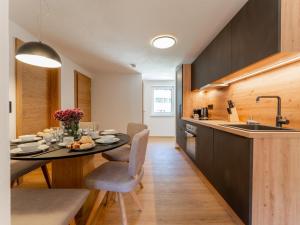 a kitchen and dining room with a table and a sink at Villa Felding Top 4 in Bad Hofgastein