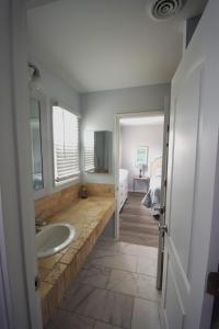 a bathroom with a sink and a bed in a room at Oceanfront vacation property - West in Emerald Isle
