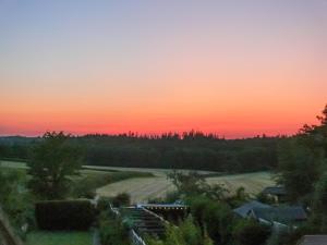 a sunset view from the roof of a house at Longford Cottage in Haven Street