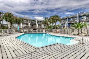 a swimming pool in front of a building at Sandcastle #6F in Dauphin Island