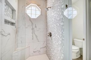 a white bathroom with a shower with white tiles at Oak Rock Point in Horseshoe Bay +45 photos