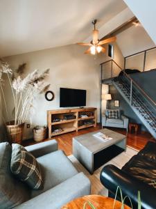 a living room with a couch and a staircase at Wm. Farmer and Sons in Hudson