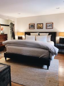 a large bedroom with a large bed with white pillows at Wm. Farmer and Sons in Hudson