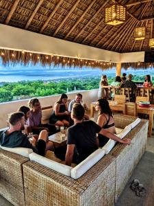 a group of people sitting in a restaurant at Villa Bonobo in Puerto Escondido