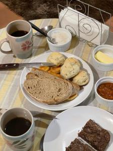 a table with two plates of food and two cups of coffee at Valizas 1900 in Barra de Valizas
