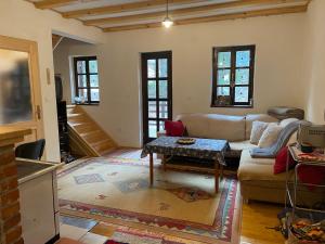 a living room with a couch and a table at Moonica Rujiste in Mostar