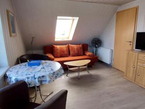 a living room with a couch and a table at Cosy Apartment Ostsee in Zierow with Terrace in Zierow