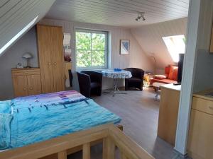 a bedroom with a bed and a table in a room at Cosy Apartment Ostsee in Zierow with Terrace in Zierow