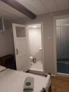 アイワルクにあるMimosa House Ayvalıkのベッドルーム1室(ベッド1台付)、バスルーム(シャワー付)が備わります。