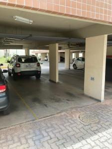 a parking lot with cars parked in a parking garage at Flats Condomínio Park Ville by CentoEdez in Brasilia