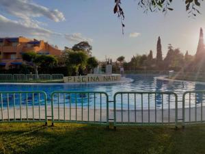 a swimming pool with a fountain in a park at Casa Vera-Playa in Vera