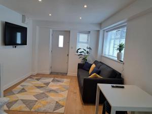 a living room with a couch and a table at Modern city house in Southampton +2 photos