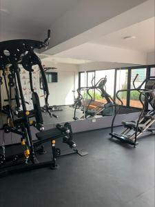 a gym with several tread machines in a room at Apartamento en Miraflores con AC in Lima