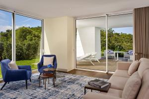 a living room with a couch and chairs at Penha Longa Resort in Sintra