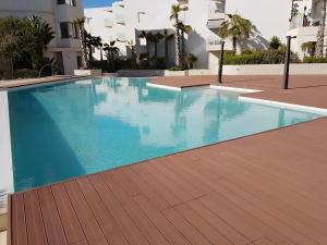 a swimming pool in the middle of a building at Apparemment Rockisland in Mohammedia