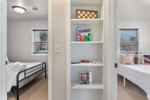 a small room with a bed and a room with a closet at Charming Home-Pet-Friendly-LG Fenced Backyard in Rapid City +22 photos