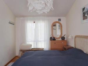a bedroom with a bed and a mirror and a dresser at 6 person holiday home in ÅKERSBERGA-By Traum in Åkersberga
