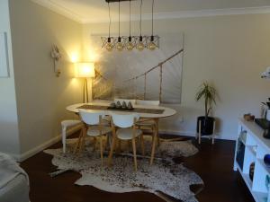 a dining room with a table and chairs at Sunny 2 bed Restaurants beach at door Pets O.K in Sydney