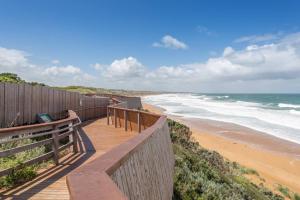 a wooden pathway to the beach with a laptop on it at Logans Beach Whale Nursery Apartments - The Loft in Warrnambool