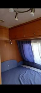 タラゴナにあるHotel caravana Guadalupeのベッドと窓が備わる小さな客室です。