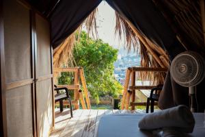 a room with a bed and a window with a view at Traveler Hostel in San Gil