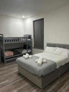 a bedroom with a bed and two bunk beds at Nice Ensuite Rooms close to Anfield Stadium & city centre in Liverpool