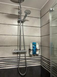 a shower in a bathroom with a shower head at Nice Ensuite Rooms close to Anfield Stadium & city centre in Liverpool