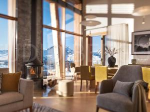 a living room with a view of mountains through the windows at Chalet Les Arcs 1800, 8 pièces, 14 personnes - FR-1-686-29 in Arc 1800