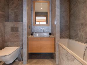 a bathroom with a sink and a tub and a toilet at Chalet Les Arcs 1800, 8 pièces, 14 personnes - FR-1-686-29 in Arc 1800