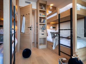 a room with two bunk beds and a closet at Chalet Les Arcs 1800, 8 pièces, 14 personnes - FR-1-686-29 in Arc 1800