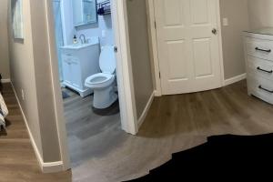 a bathroom with a white toilet and a sink at Bungalow near Winnisquam Lake! Sleeps 14 in Sanbornton