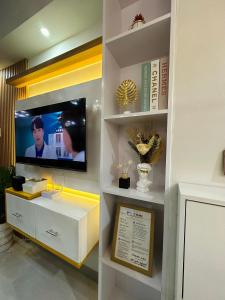 a living room with a tv in a wall at Luxe Staycation S Residences Tower 3 MOA in Manila