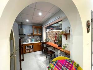 an archway in a kitchen with a table and chairs at Peaceful house in Hanoi