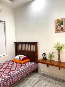 a bedroom with a bed and a table and a window at Peaceful house in Hanoi