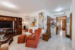 a living room with a couch and a tv at Dream Home - Heraklion Center in Heraklio