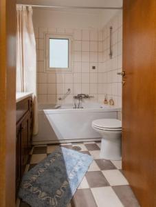 a bathroom with a tub and a toilet and a sink at Dream Home - Heraklion Center in Heraklio