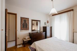 a bedroom with a bed and a dresser and a mirror at Dream Home - Heraklion Center in Heraklio