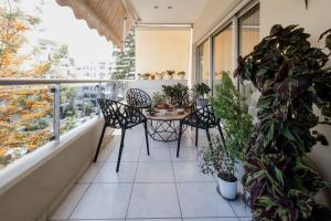 a balcony with a table and chairs and plants at Dream Home - Heraklion Center in Heraklio