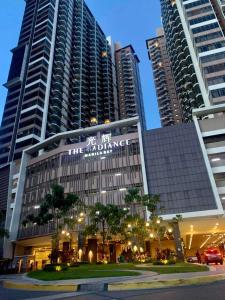 a building in the middle of a city with tall buildings at The Radiance Manila Bay in Manila