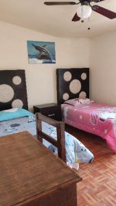 a living room with two beds and a table at ApartADE in Saltillo