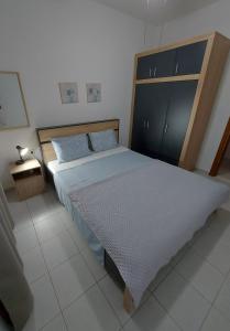 a bedroom with a large bed with a wooden headboard at Andre House in Mesimvría